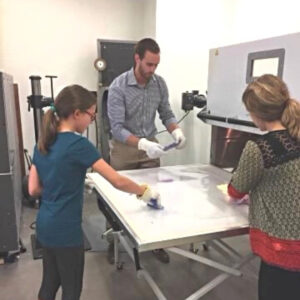 Girl making a brace with orthotists at National Scoliosis Center